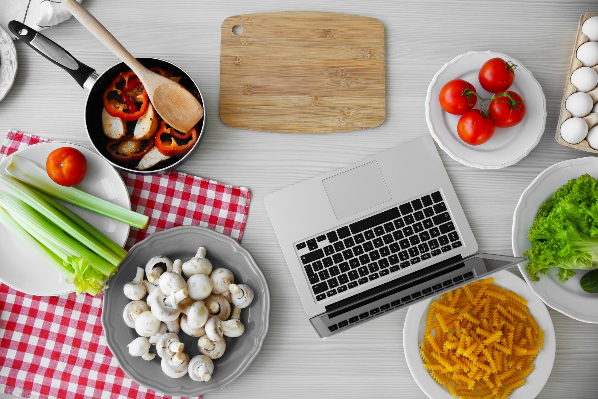 Workspace with ingredients and laptop